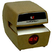 Prints a 6 digit automatically advanced number on the same line as the date and time.An LED clock reads out time in red numerals on a black background.Solid-state electronic circuitry for consistent impressions.Solid brass typewheels - superior quality.